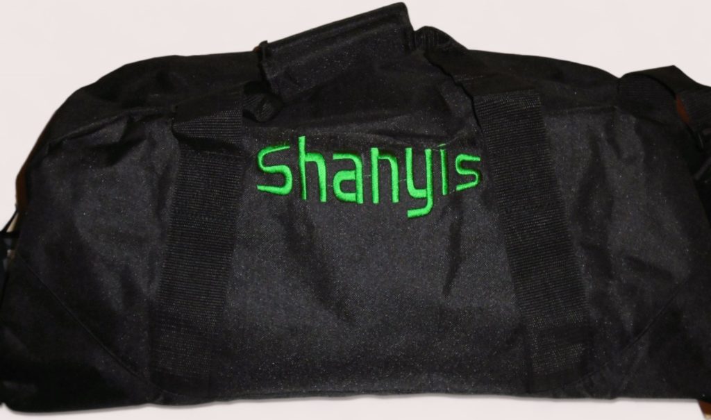 Custom duffle bag in black with green embroidered name Shanyis