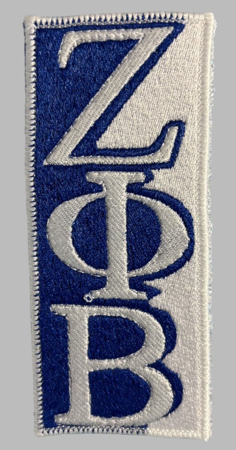 Iron-on embroidered patch featuring stacked ZPB Greek letters in white on a royal blue background, heat-seal backing, size 2 3/16″ x 5 1/4″