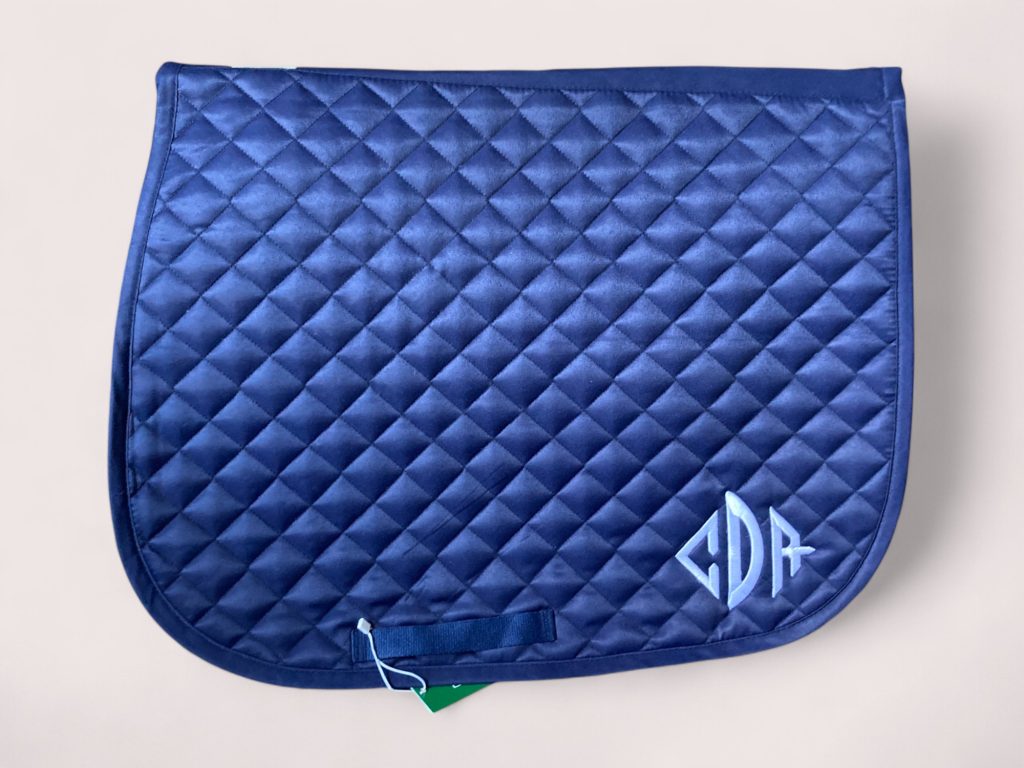 Navy saddle pad with light blue CDR monogram embroidery