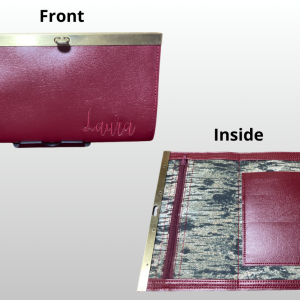Red leather bifold wallet with embroidery and marbled patterned interior.